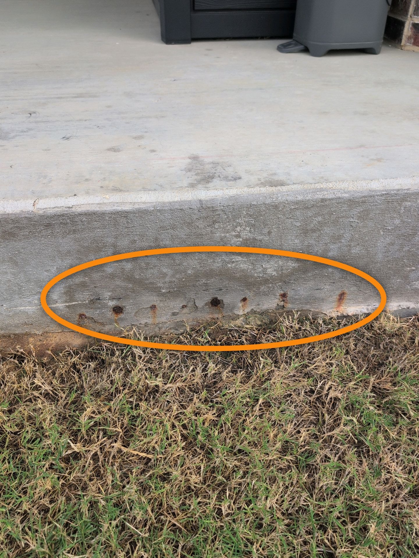 Concrete foundation with exposed rebar rust — inspection finding