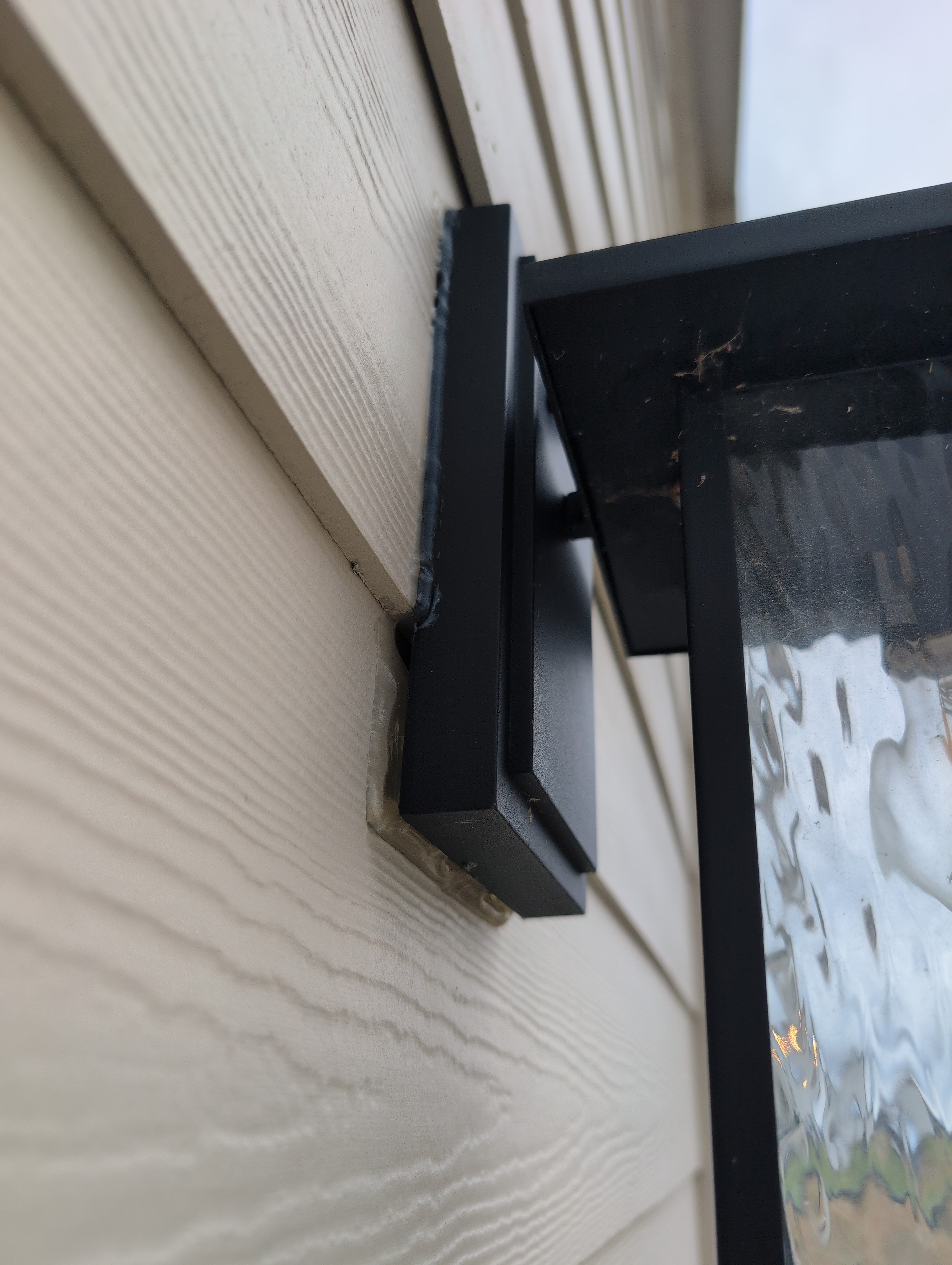 Deck post base with improper installation — inspection finding
